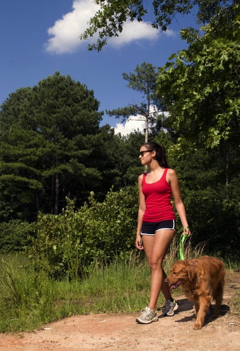 The young woman depicted here was walking her dog on a sunny Georgia morning. Dressed in shorts and a sleeveless shirt, she had applied sunscreen to her sun-exposed skin, which protected her from the sun’s damaging ultraviolet rays. The inclusion of sunglasses as an accessory, was an excellent way to shield her eyes from the sun as well.