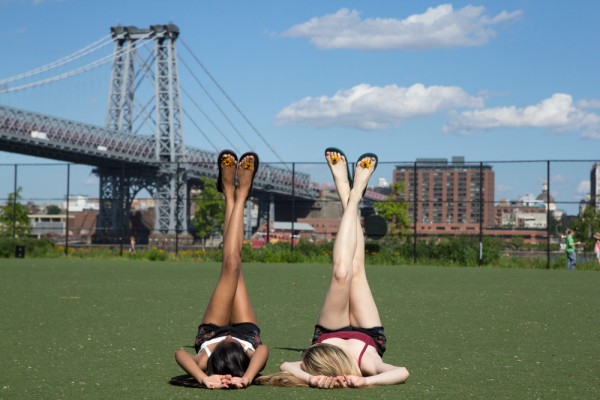 Ally and Shakera relax on the field–their no-hazard barefoot style is the ultimate summer bliss.