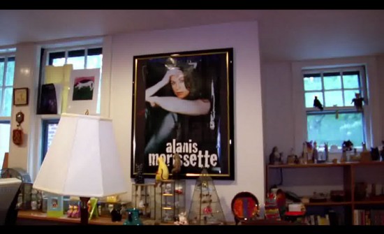 A scene from Transcendent Man displaying Kurzweils chotchkies and Alanis Morissette poster